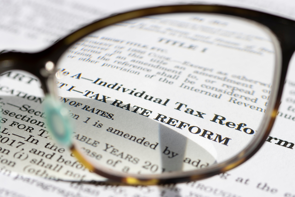 Closeup of the Tax Cuts and Jobs Act documents highlighting the exclusions relevant to 1031 exchange and the associated tax benefits in property and investment planning